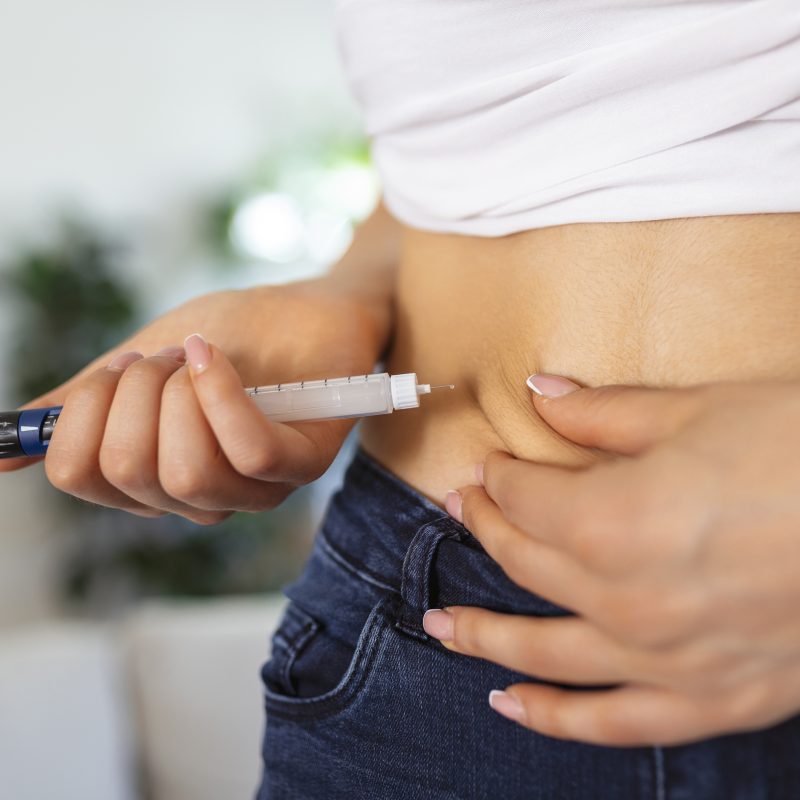 Person injecting semaglutide medication for weight loss